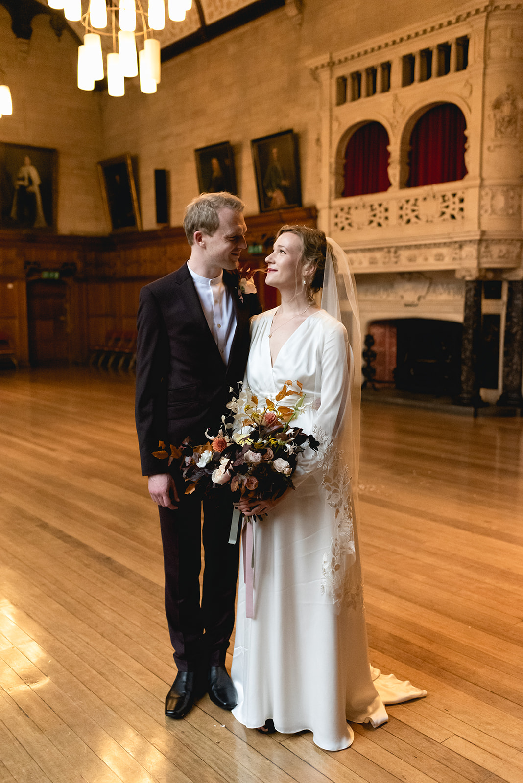 wedding portrait of bride and groom looking at each other at Oxford Town Hall by Midlands wedding photographer byGarazi