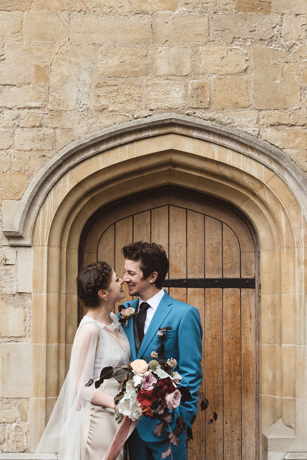 Bride and groom looking at each other in a doorway in Oxford by Oxfordshire wedding photographer byGarazi